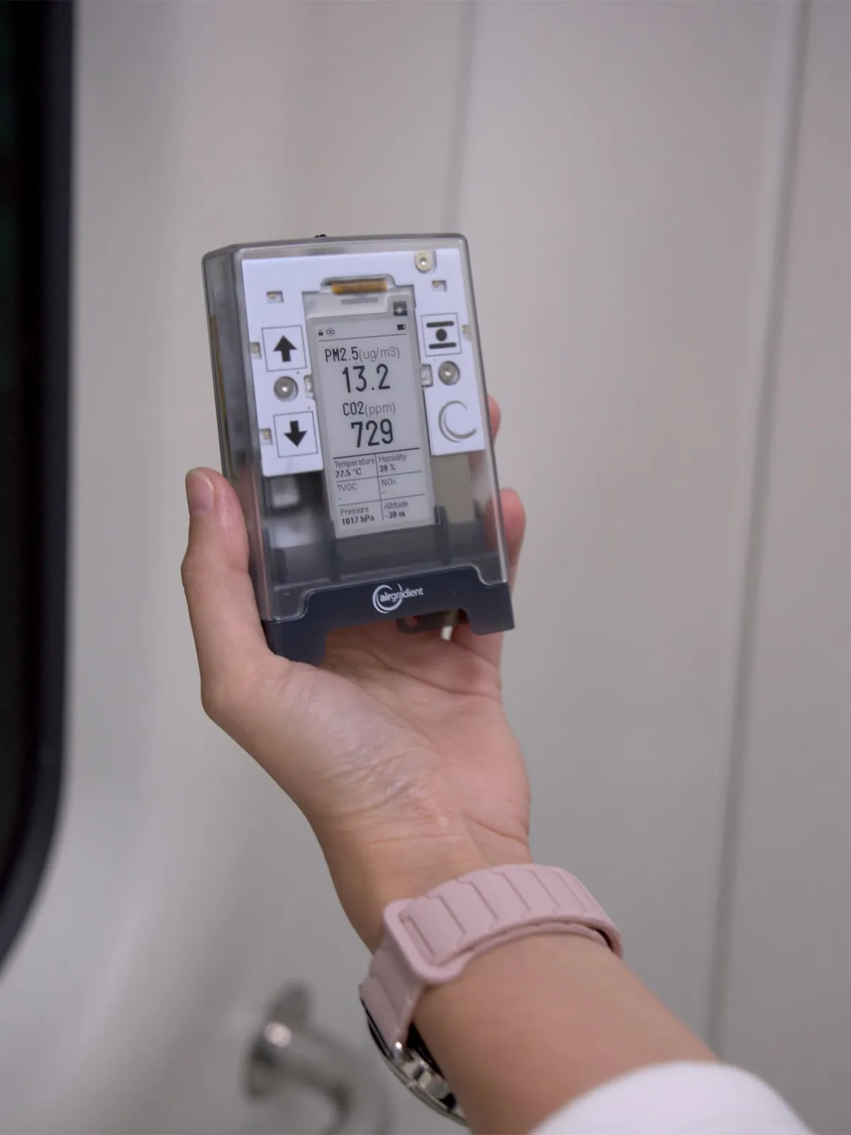 AirGradient Go held on a subway train